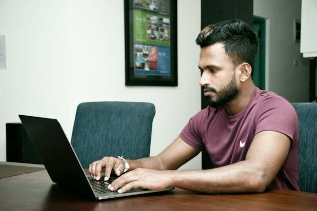 Student attending a live online class on a laptop